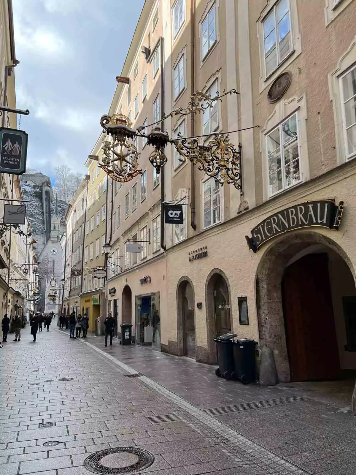Entryway to Sternbräu in Salzburg’s Old Town on an overcast day, with its arched passage, historic signage, and stone-paved courtyard leading into the traditional Austrian brewery and restaurant.