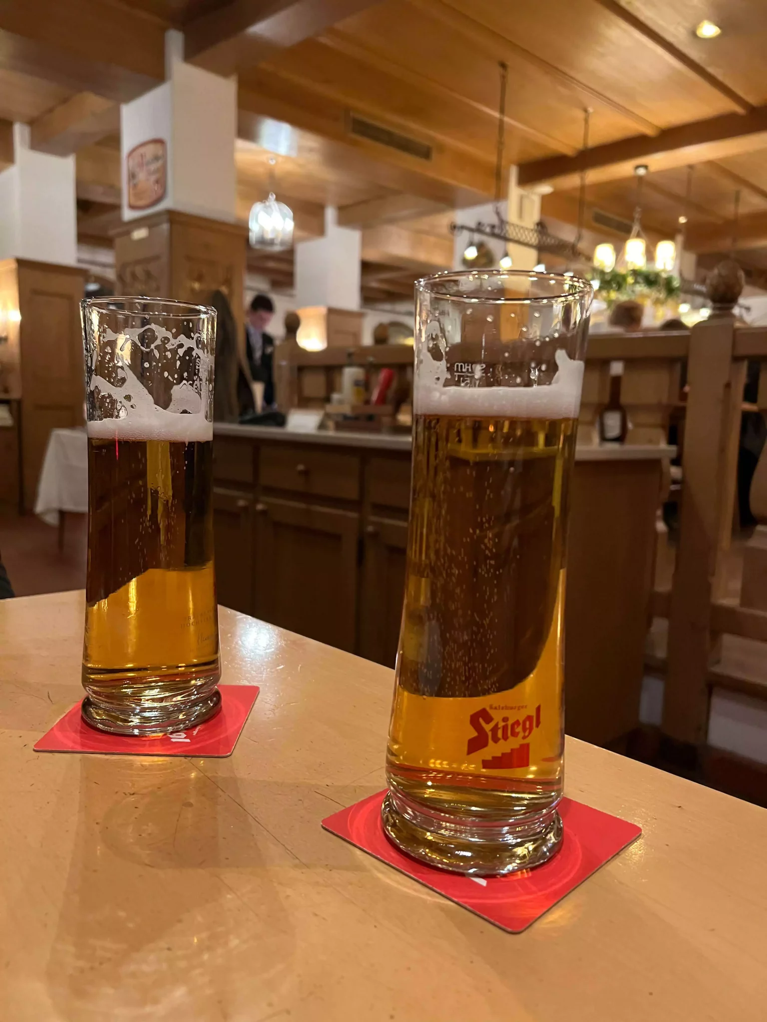 A selection of beers served at Braurestaurant IMLAUER in Salzburg, Austria, with tall glasses showcasing golden hues and frothy heads. The variety reflects the restaurant’s strong brewing tradition and classic Austrian beer culture.