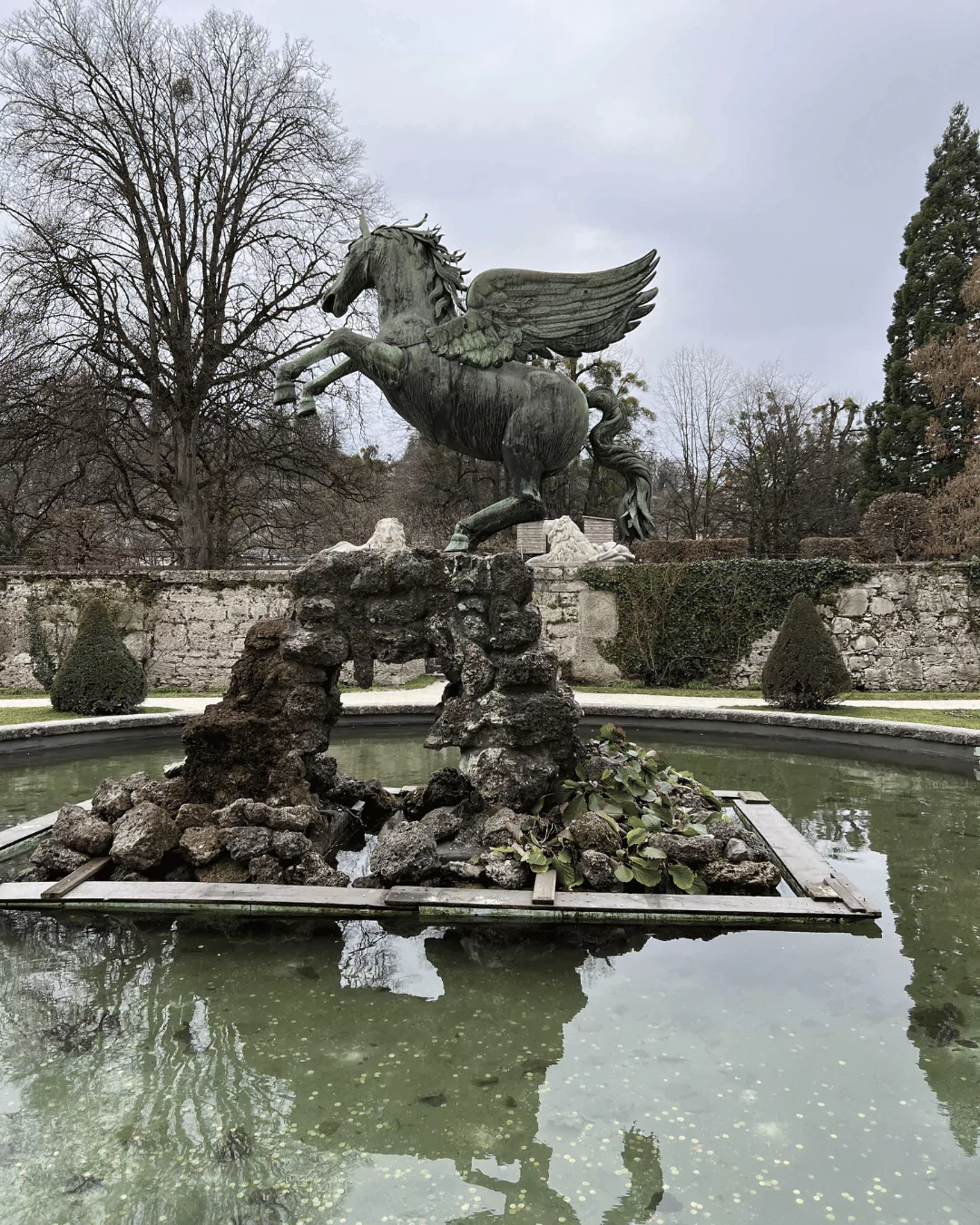 A statue of a unicorn rises majestically over a fountain at Schloss Mirabell in Salzburg, Austria. The mythical creature, sculpted in stone, adds a whimsical and regal touch to the palace’s ornate garden setting.