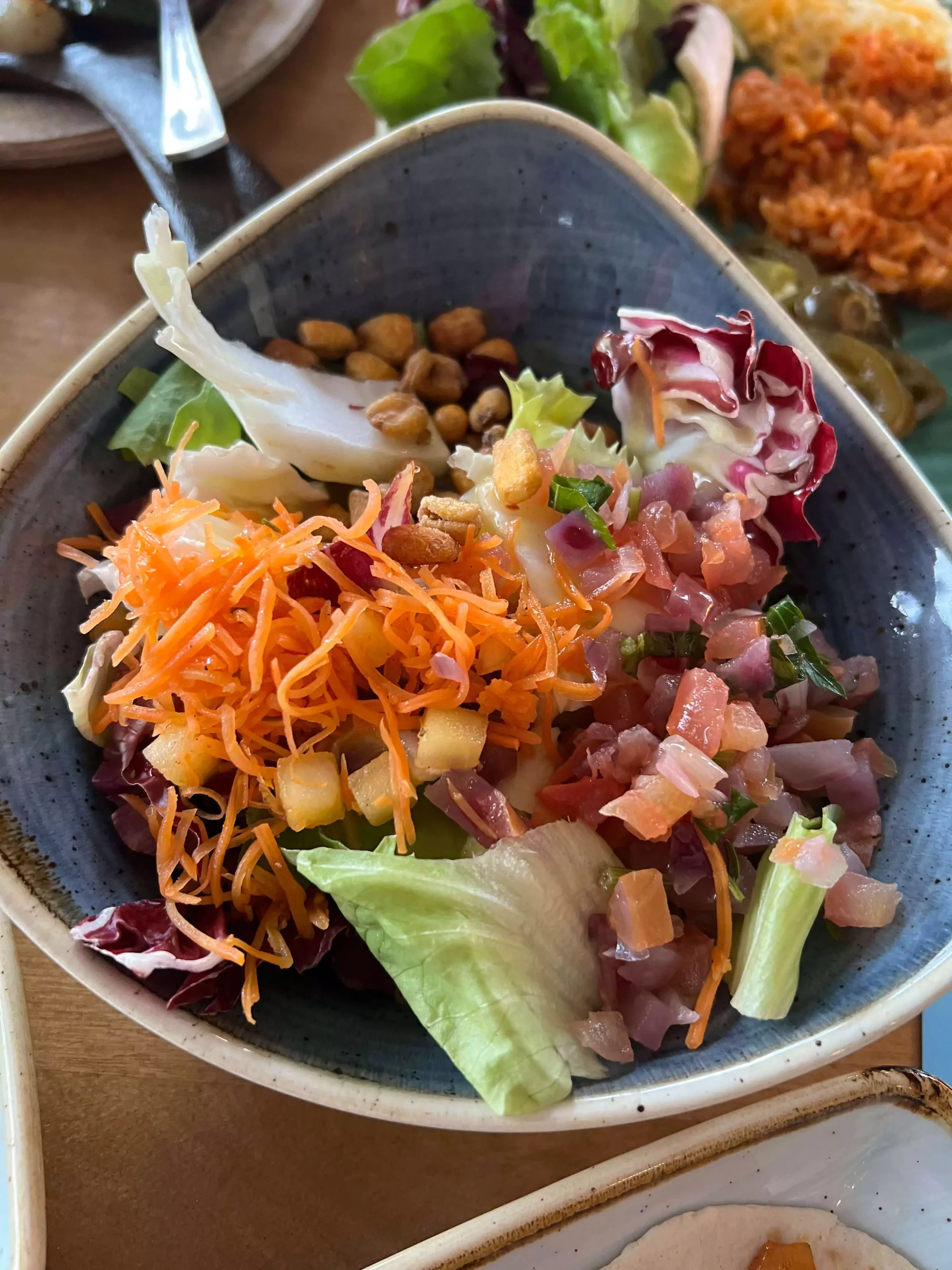 Fresh side salad served at Sausalitos in Nuremberg, Germany, featuring mixed greens, cherry tomatoes, cucumbers, and shredded carrots, lightly dressed and served as part of a casual lunch.