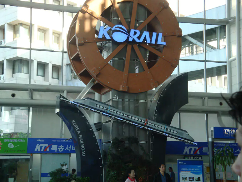 Korail logo sign with the words ‘KORAIL’ beside a stylized swoosh globe