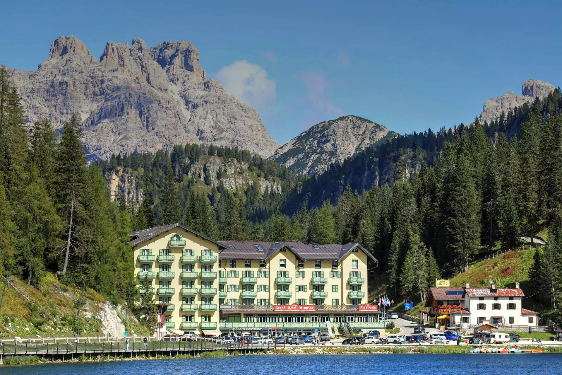 The Grand Hotel Misurina in Veneto, Italy, nestled beside the crystal-clear Lake Misurina with the dramatic Dolomite mountains in the background