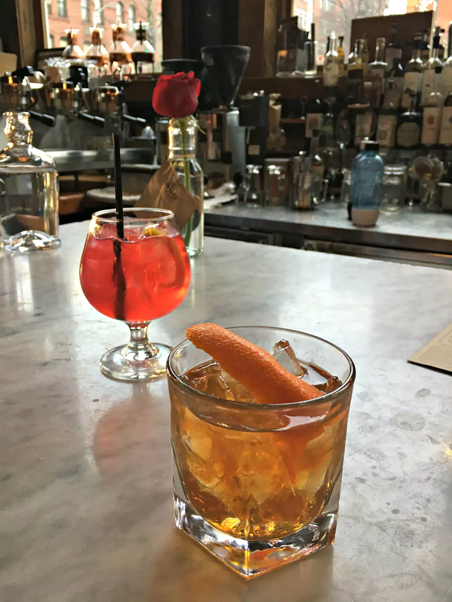 Interior of Local 360 Bar and Restaurant in Seattle, featuring rustic wood décor, exposed brick walls, and a cozy, farm-to-table atmosphere. The space blends urban charm with sustainable, locally sourced dining.