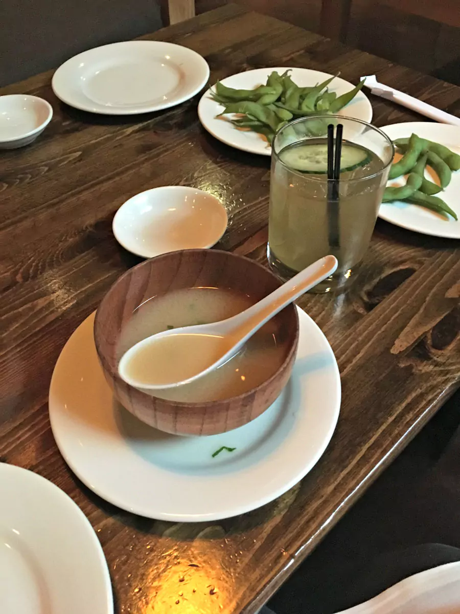 Sushi platter at Umi Sake House in Seattle, artfully arranged with colorful rolls, fresh sashimi, and garnishes. Served on a sleek black plate, the presentation reflects the restaurant’s modern vibe and focus on high-quality Japanese cuisine.