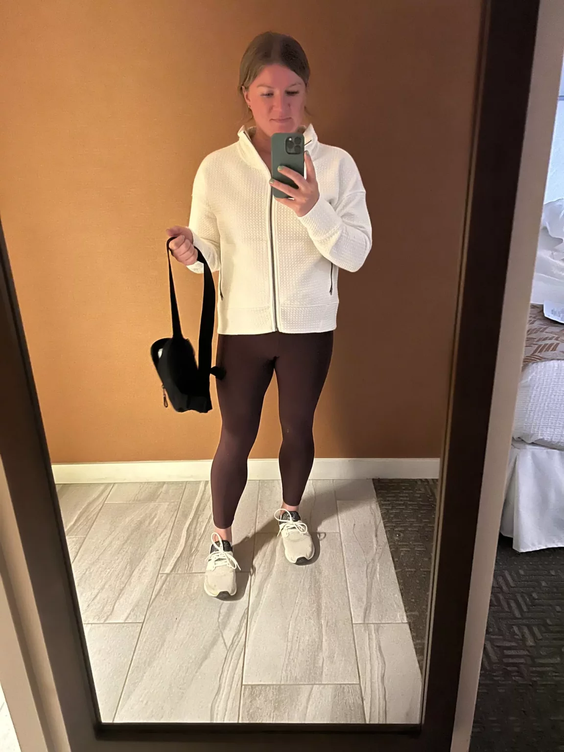 Outfit for a Haleakalā sunrise tour in Hawaii, including a warm jacket, leggings, and a beanie to stay cozy in the chilly early-morning mountain air.