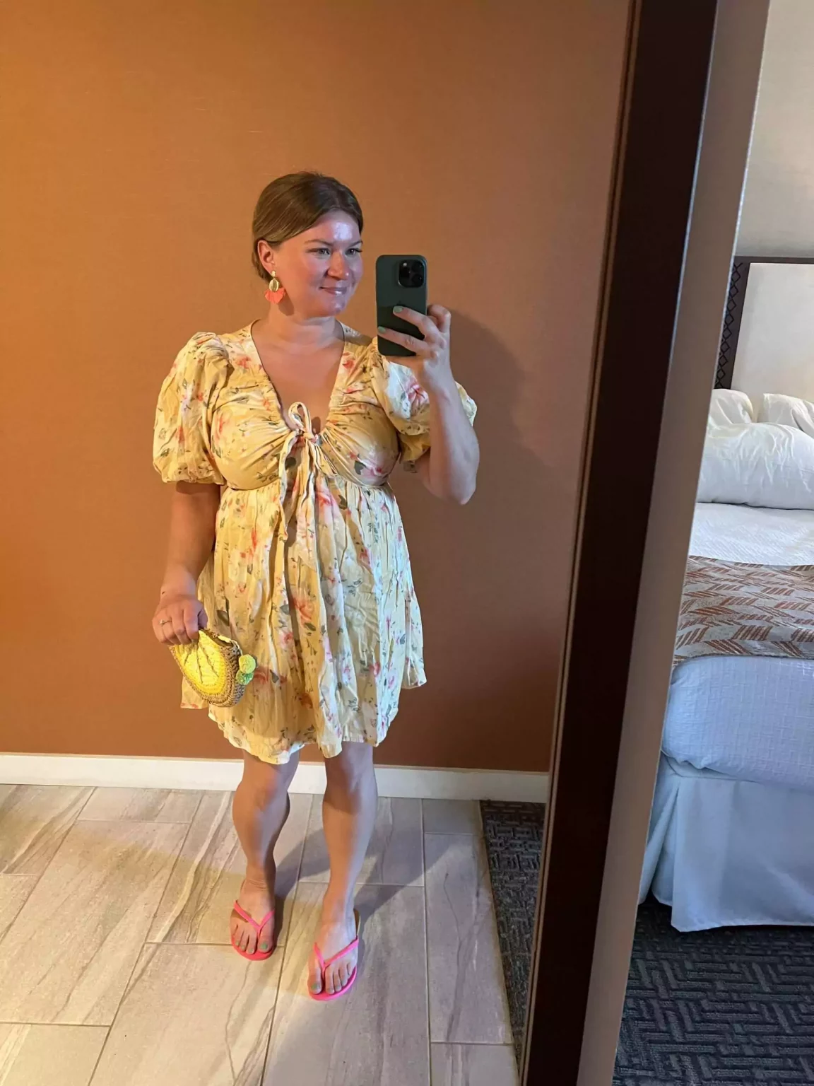 Katie dressed for a Hawaiian luau, wearing a flowy floral dress paired with sandals