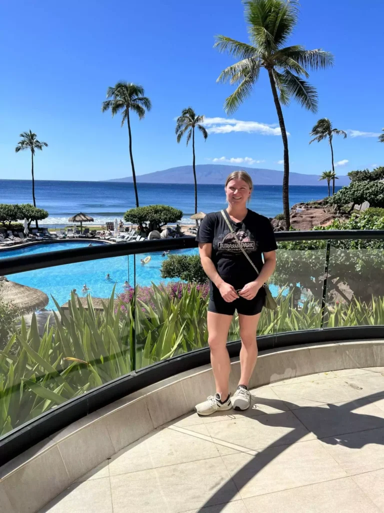 Katie dressed for a Maui helicopter ride in Hawaii, wearing a lightweight jacket, fitted top, and pants with closed-toe shoes for safety and comfort. Her practical yet stylish outfit is perfect for staying comfortable while enjoying panoramic aerial views of the island.