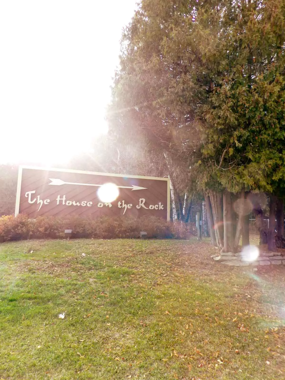 Entrance sign for House on the Rock in Wisconsin with bold lettering and rustic stone base, marking one of the state's weird Wisconsin roadside attractions.